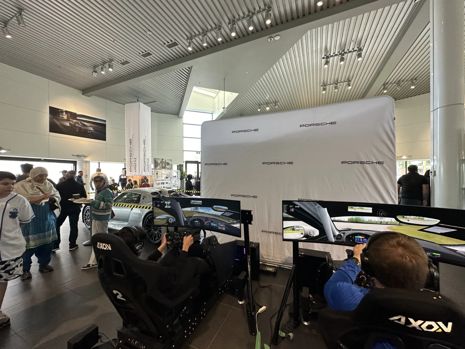 A row of Axon simulators in use by guests at Porsche Centre Victoria